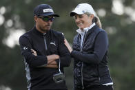 Rickie Fowler, left, and Heidi Ueberroth smile on the 10th green on the Spyglass Hill Golf Course during the first round of the AT&T Pebble Beach National Pro-Am golf tournament Thursday, Feb. 1, 2024, in Pebble Beach, Calif. (AP Photo/Eric Risberg)