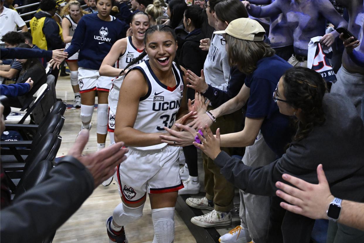 UConn's Azzi Fudd celebrates with fans after the Huskies' win over Texas on Nov. 14, 2022. (AP Photo/Jessica Hill)