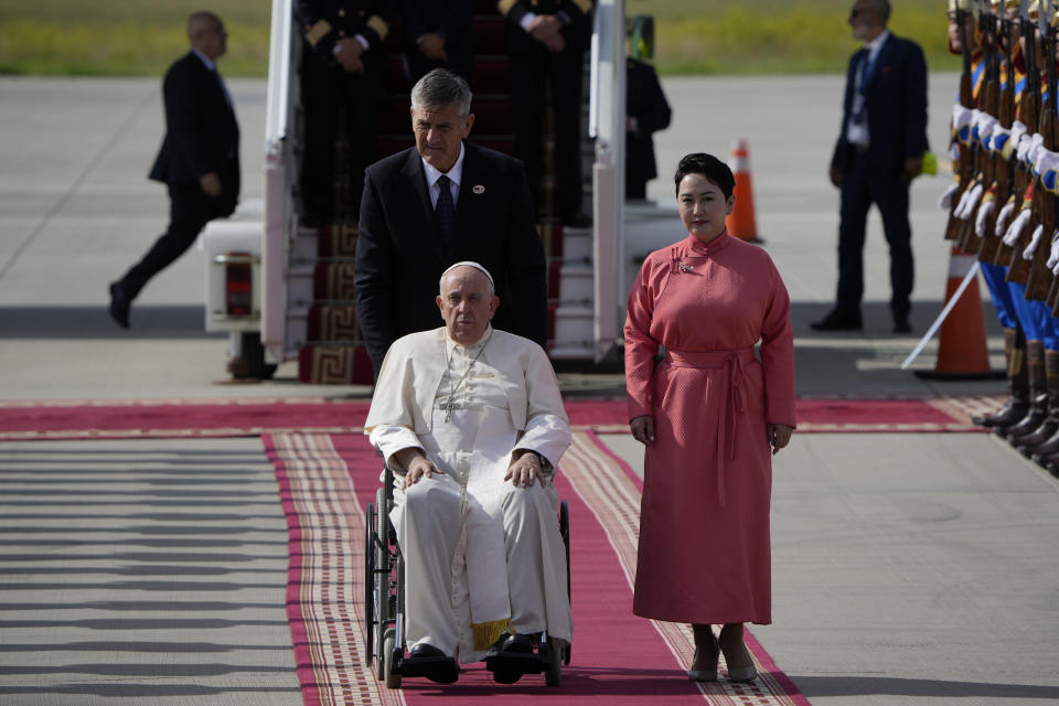 Pope Francis is received by the Foreign Minister of Mongolia, Batmunkh Battsetseg, right, as he arrives at Ulaanbaatar's International airport Chinggis Khaan, Friday, Sept. 1, 2023. Pope Francis is traveling to Mongolia to encourage one of the world's smallest and newest Catholic communities. It's the first time a pope has visited the Asian country and comes at a time when the Vatican's relations with Mongolia's two powerful neighbors, Russia and China, are once again strained. (AP Photo/Ng Han Guan)