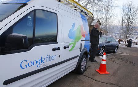 A technician gets cabling out of his truck to install Google Fiber in a residential home in Provo, Utah, U.S. January 2, 2014. REUTERS/George Frey/File Photo