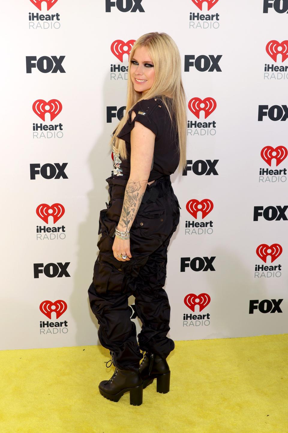 Avril Lavigne, black lace-up boots, iheartradio music awards 2024, shoes, combat boots, high-heeled combat boots, red carpet