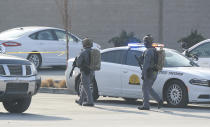 Emergency responders comb the parking lot outside Dillard's at Fashion Place Mall in Murray, Utah, after a shooting on Sunday, Jan. 13, 2019.(Francisco Kjolseth/The Salt Lake Tribune via AP)