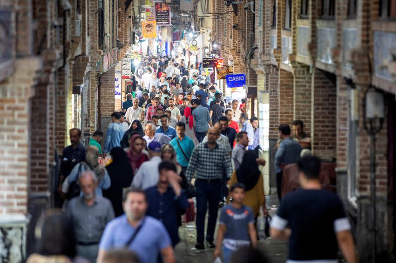 FILE PHOTO: People shop in a street called Grand Bazaar in downtown Tehran