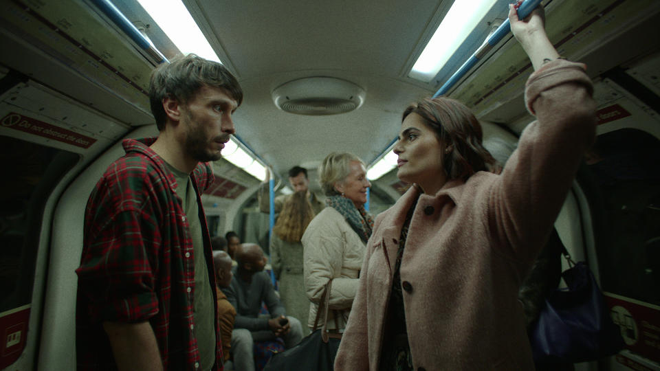 A man and woman standing in a crowded London underground car; still from 'Baby Reindeer'