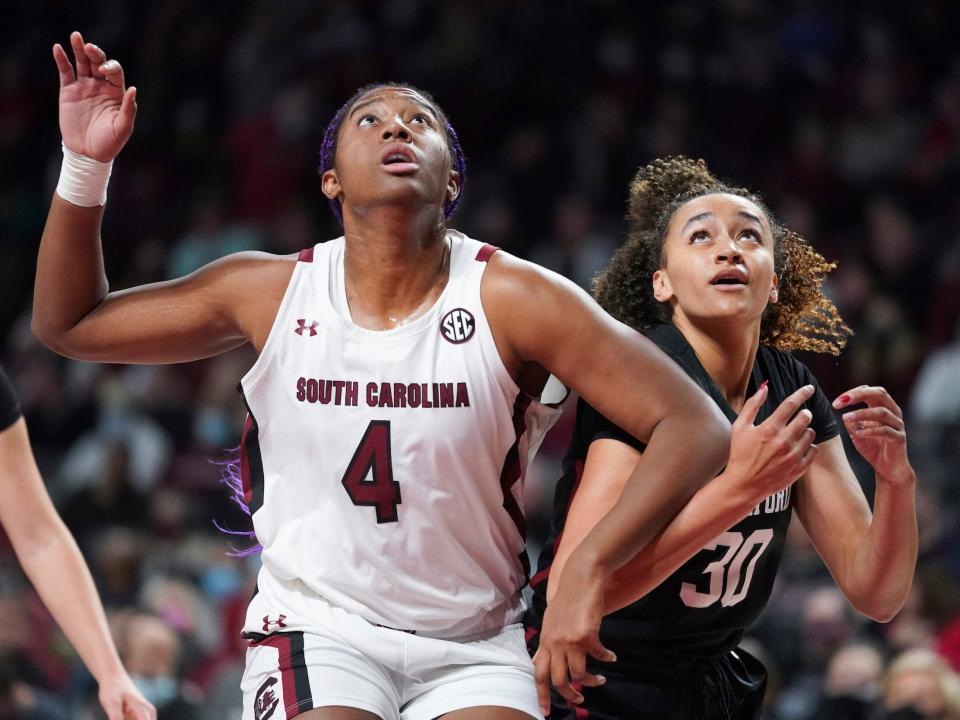 Haley Jones (right) and Aliyah Boston battle for a rebound.