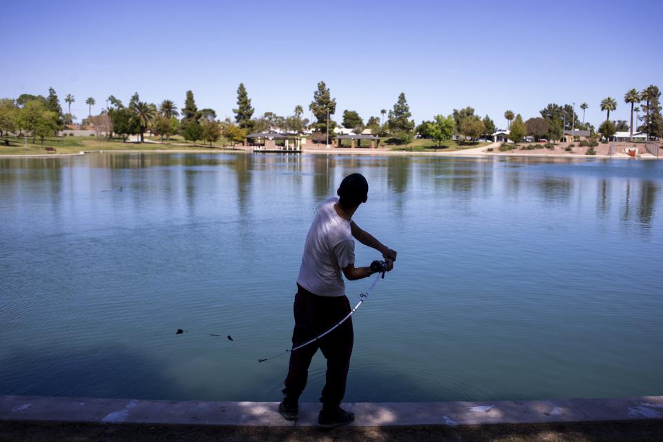 Danny Saenz fishes on March 24, 2020, at Kiwanis Park in Tempe, Ariz.
