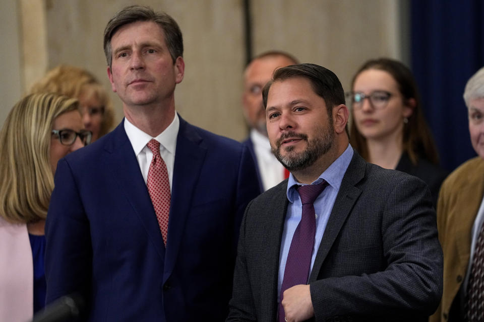 U.S. Rep. Greg Stanton, D-Ariz., left, and U.S. Rep. Ruben Gallego, D-Ariz., listen during a news conference at the Capitol, Thursday, April 6, 2023, in Phoenix. Officials were discussing newly announced water conservation funding for Gila River Indian Community and water users across the Colorado River Basin aimed to protect the stability and sustainability of the Colorado River System. (AP Photo/Matt York)