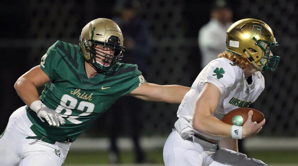 STVM defensive lineman Bryson Getz, left, rushes Ursuline quarterback Brady Shannon during the second half of a high school football game, Friday, Oct. 1, 2021, in Akron, Ohio.