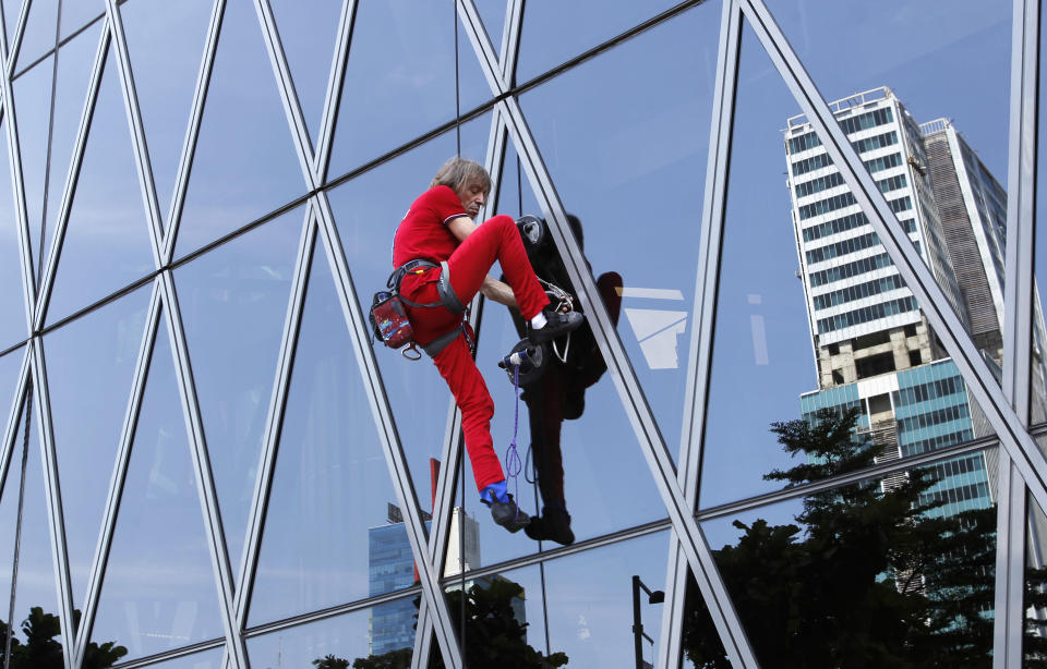 French climber Alain Robert, a rock climber who has become famous for climbing known buildings worldwide, climbs the 215m (705 feet) high, 50 floors Bakrie Tower building in Jakarta March 25, 2012. REUTERS/Supri