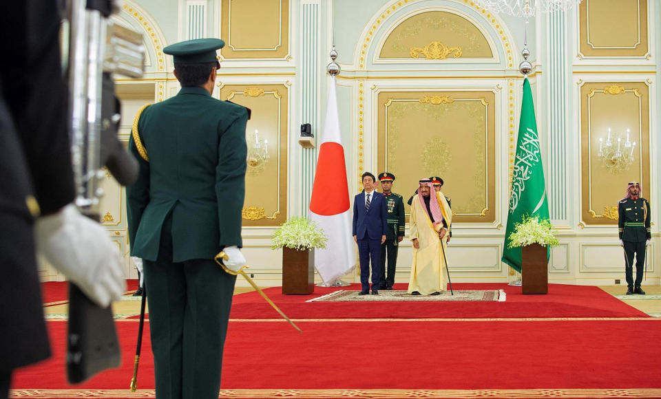 In this photo released by Saudi Press Agency, SPA, Saudi King Salman, center right, stands with Japan's Prime Minister Shinzo Abe, in Riyadh, Saudi Arabia, Sunday, Jan. 12, 2020. (Saudi Press Agency via AP)