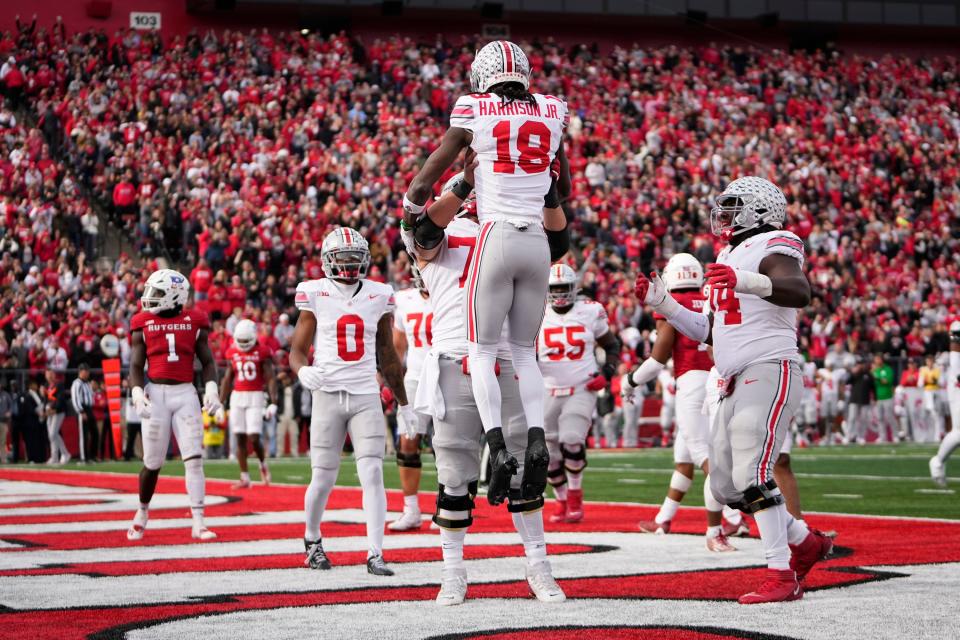 Nov 4, 2023; Piscataway, New Jersey, USA; Ohio State Buckeyes offensive lineman Carson Hinzman (75) hoists wide receiver Marvin Harrison Jr. (18) after he made a touchdown catch during the NCAA football game against the Rutgers Scarlet Knights at SHI Stadium. Ohio State won 35-16.