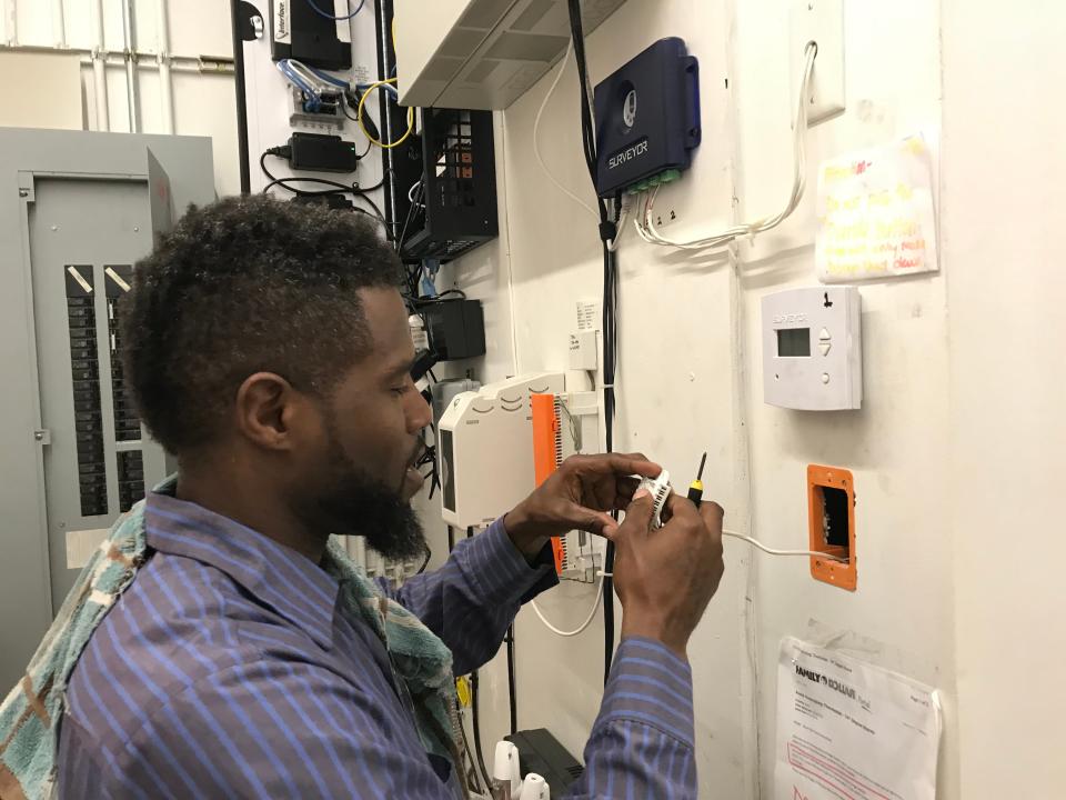 Artic Mechanical refrigeration technician Randy Philpot works on a thermostat at a Phoenix Family Dollar Store