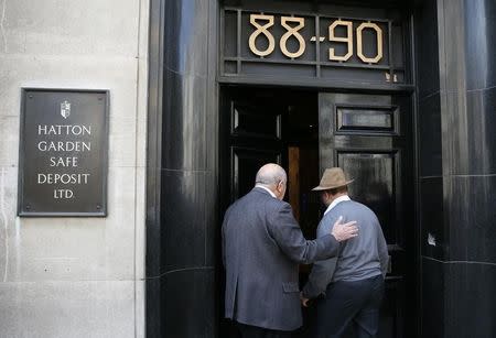 Men enter a safe deposit building on Hatton Garden in central London April 9, 2015. REUTERS/Stefan Wermuth