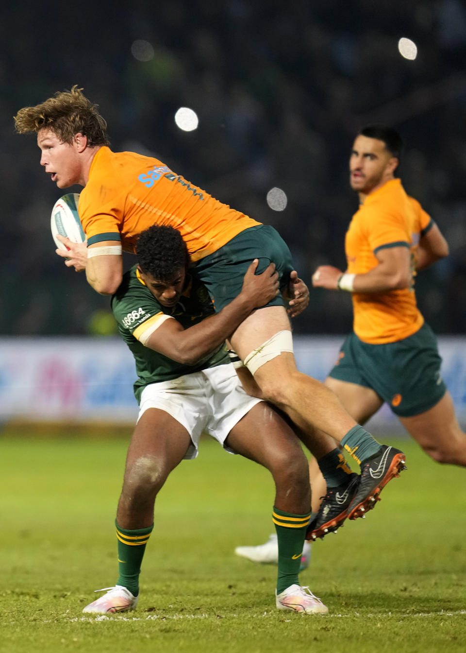 Australia's Michael Hooper, top, is tackled by South Africa's Canan Moodie during the Rugby Championship test match between South Africa and Australia at Loftus Versfeld stadium in Pretoria, South Africa, Saturday, July 8, 2023. (AP Photo/Themba Hadebe)