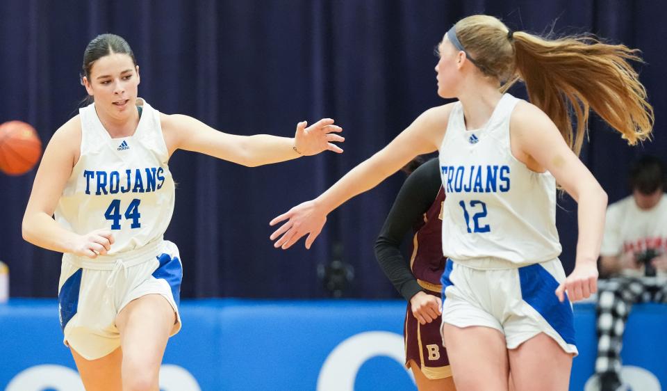 Bishop Chatard Trojans center Anna Caskey (44) high-fives against Bishop Chatard Trojans Olivia Berzai (12) on Tuesday, Jan. 30, 2024, during the game at Bishop Chatard High School in Indianapolis.