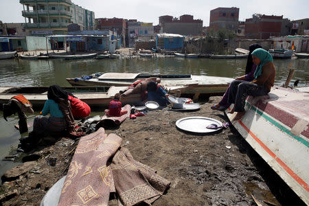 Women of Egypt's Nile Delta village of El Shakhluba wash their household items at the canal, in the province of Kafr el-Sheikh, Egypt May 5, 2019. Picture taken May 5, 2019. REUTERS/Hayam Adel