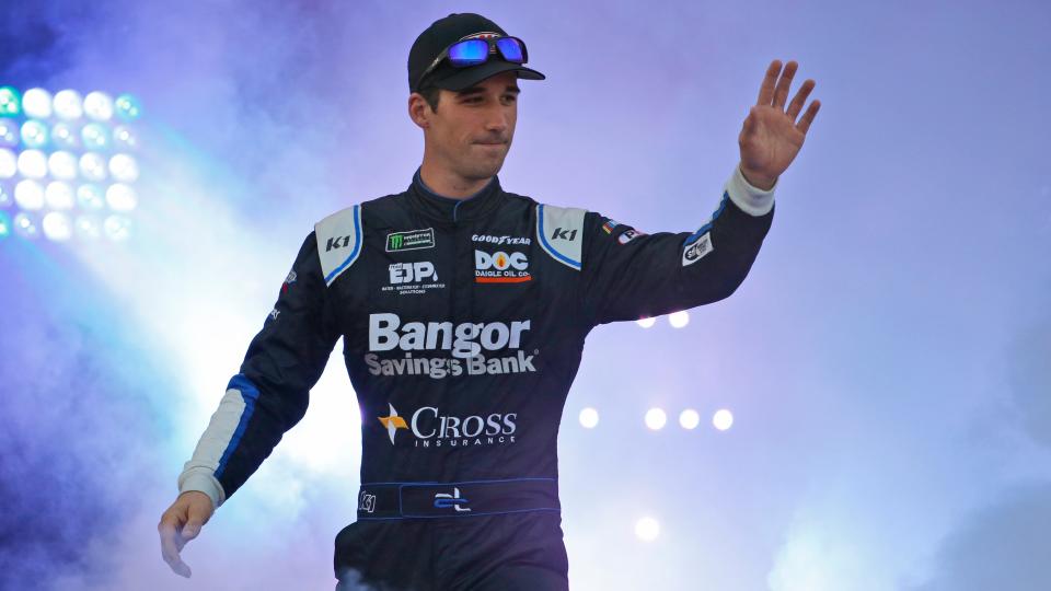 Austin Theriault greets fans during driver introductions for the NASCAR Monster Energy Cup series auto race at Richmond Raceway in Richmond, Virginia, Sept. 21, 2019. The NASCAR driver-turned-politician wants the opportunity to challenge Democratic U.S. Rep. Jared Golden in Maine.