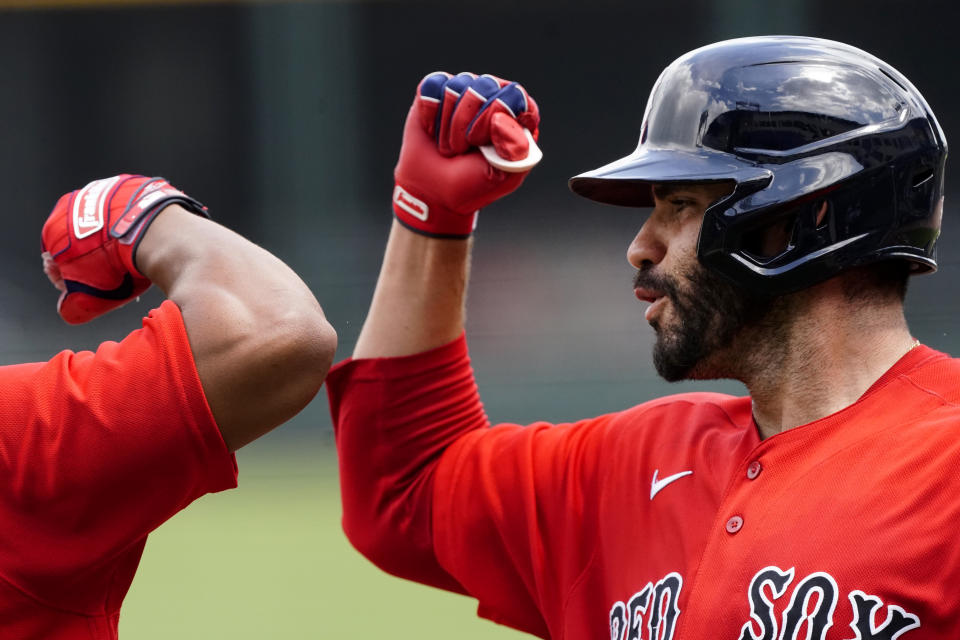 Boston Red Sox designated hitter J.D. Martinez celebrates with a teammate after hitting a home run in the third inning of a spring training baseball game against the Atlanta Braves ON Monday, March 29, 2021, in North Port, Fla. (AP Photo/John Bazemore)