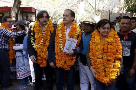 Felipe de la Cruz, spokesman of the parents of missing students, stands with members of the Inter-American Commission on Human Rights (IACHR) Francisco Cox, Carlos Beristain and Claudia Paz while arriving to deliver their final report on the disappearance of the 43 students at Ayotzinapa teacher training college in Tixtla, Guerrero state, Mexico, April 27, 2016. REUTERS/Ginnette Riquelme