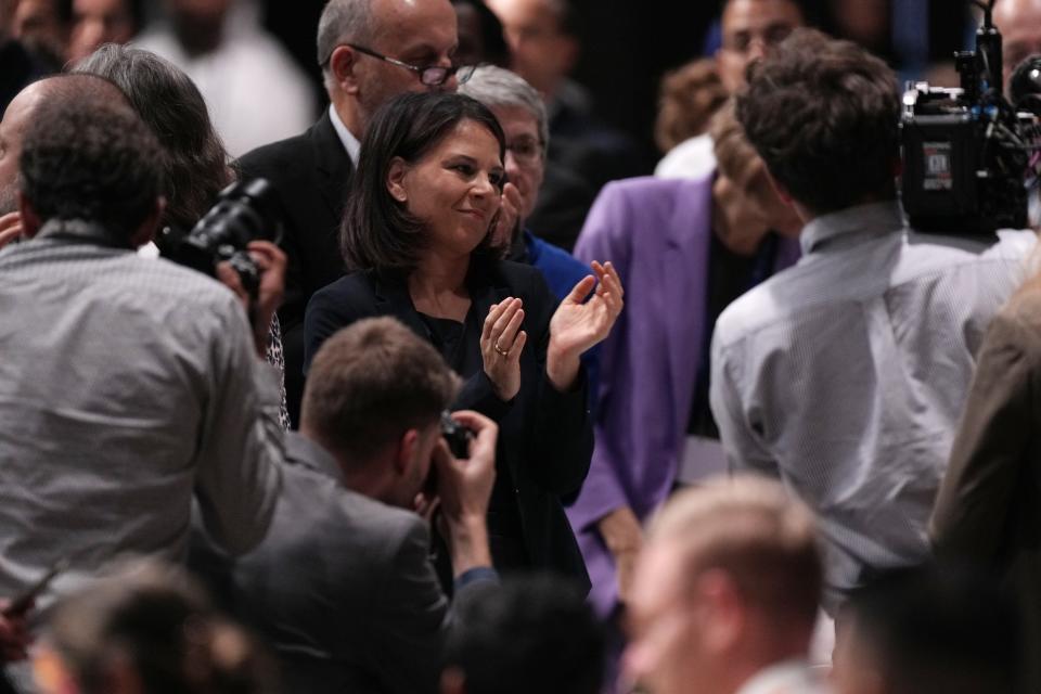 Germany Foreign Minister Annalena Baerbock stands and claps during a plenary session at the COP28 U.N. Climate Summit, Wednesday, Dec. 13, 2023, in Dubai, United Arab Emirates. (AP Photo/Kamran Jebreili)