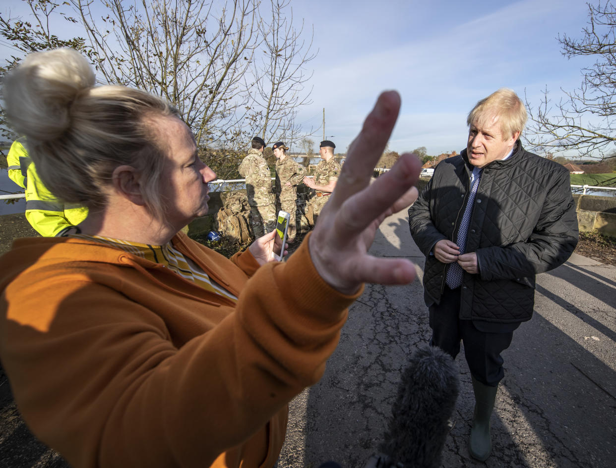 Prime Minister Boris Johnson chats to a member of the public during a visit to Stainforth, Doncaster, to see the recent flooding.