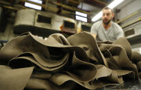 A pile of hats is seen in Borsalino's hat factory, in Spinetta Marengo, near Alessandria, Italy, Thursday, Jan. 17, 2019. Borsalino's prized felt hats are handmade by 80 workers in its Piemonte factory, many who have worked there for decades, with original machinery that use hot water and steam to transform rabbit fur into highly prized felt, that is formed into clochards, dyed and molded by hand to create the latest styles. (AP Photo/Antonio Calanni)