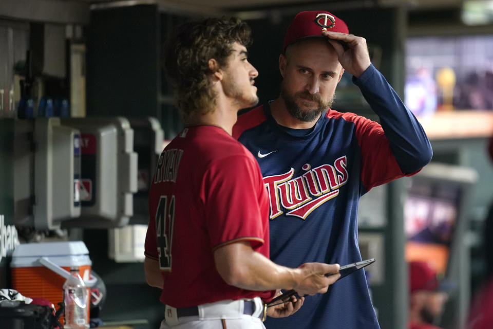 Minnesota Twins starting pitcher Joe Ryan, left, speaks with manager Rocco Baldelli after Ryan was pulled from the baseball game against the Kansas City Royals during the sixth inning Monday, Aug. 15, 2022, in Minneapolis. (AP Photo/Abbie Parr)