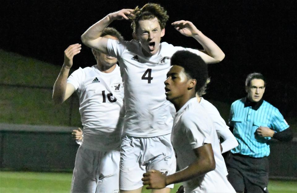 Niceville's Carsen Krider (4) tries to pump up the crowd after the Eagles tied Saturday's Class 6A boys' state soccer championship game at 1-1.