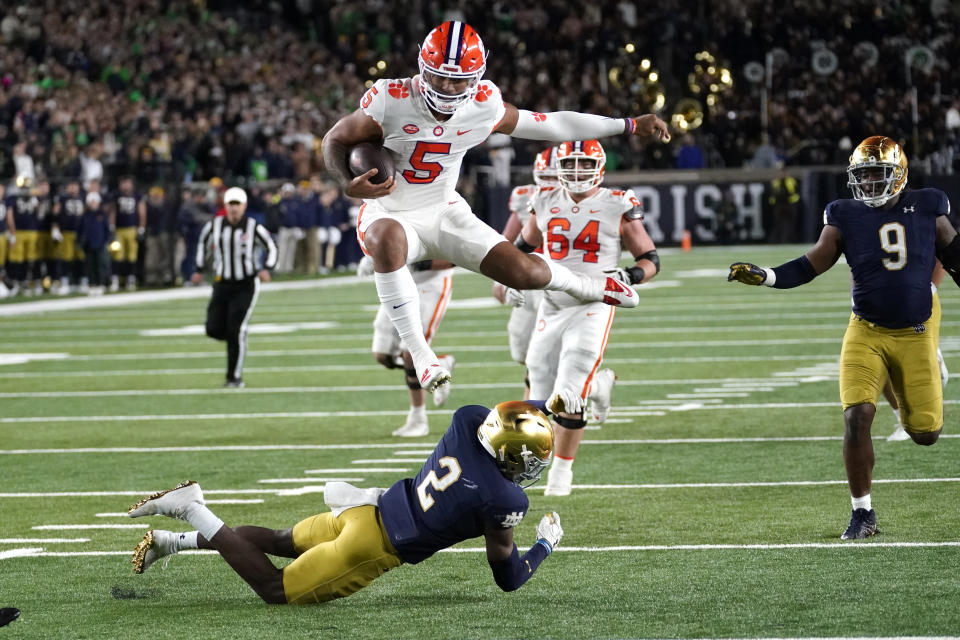 Clemson quarterback DJ Uiagalelei hurdles Notre Dame safety DJ Brown during the second half of an NCAA college football game Saturday, Nov. 5, 2022, in South Bend, Ind. Notre Dame won 35-14. (AP Photo/Charles Rex Arbogast)