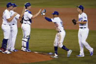 The Los Angeles Dodgers celebrate a 4-2 win over the Milwaukee Brewers in Game 1 of a National League wild-card baseball series Wednesday, Sept. 30, 2020, in Los Angeles. (AP Photo/Ashley Landis)