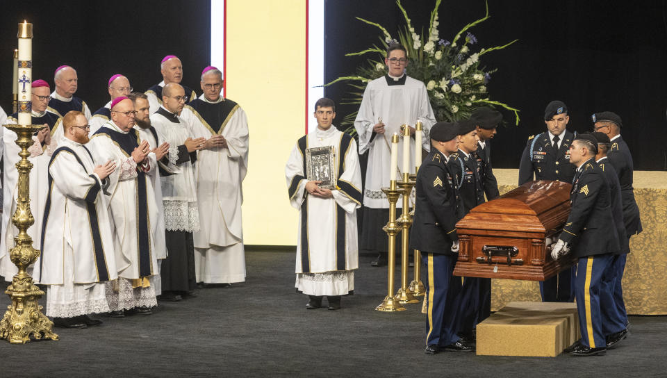 A Fort Riley honor guard places the remains of Father Emil before an alter during Kapaun's funeral mass on Wednesday, Sept., 29, 2021 in Wichita, Kan. Kapaun died in a North Korean POW camp in May of 1951. He was posthumously awarded the Medal of Honor in 2013 for his bravery in the Korean War. Kapaun's remains were identified earlier this year returned home to Kansas recently. (Travis Heying/The Wichita Eagle via AP)