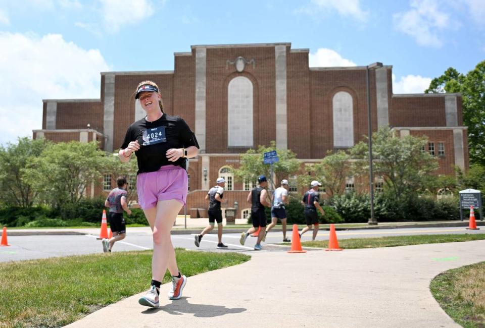 Athletes pass Rec Hall during the 13.1 mile run for the Ironman 70.3 Pennsylvania Happy Valley on Sunday, June 30, 2024.