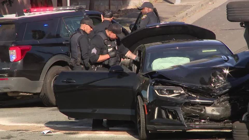 <div>Oakland police inspect a black sedan involved in a shooting and crash. May 2, 2024</div>