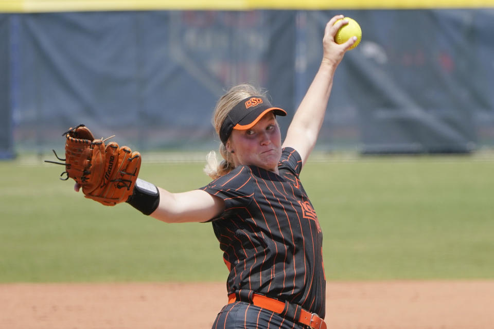 FILE - Oklahoma State's Kelly Maxwell pitches in the first inning of the NCAA college Big 12 Championship softball game against Oklahoma, in Oklahoma City on May 14, 2022. Maxwell leads Oklahoma State, and she has plenty of help. Alabama transfer Lexi Kilfoyl had 13 starts and a 2.36 ERA for the Crimson Tide last season. Freshman Kyra Aycock was one of the nation’s top pitching recruits. (AP Photo/Sue Ogrocki, File)