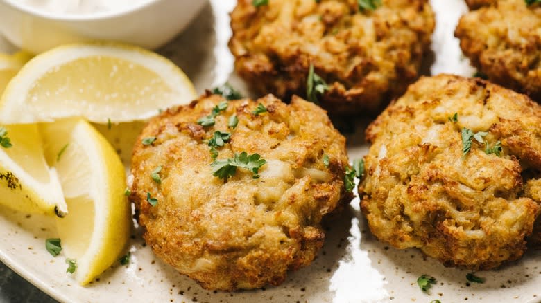 crab cakes with lemon wedges