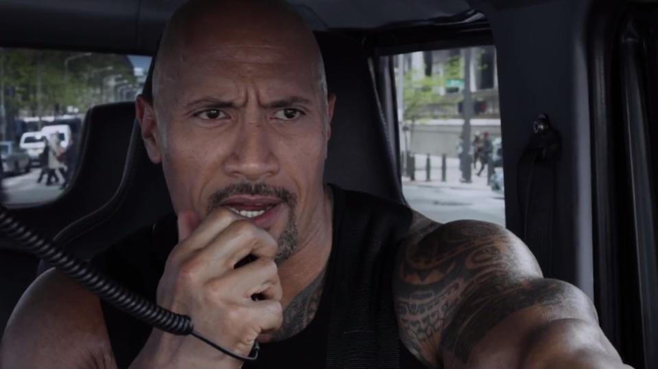 Dwayne Johnson talks into a CB radio in Fast Five