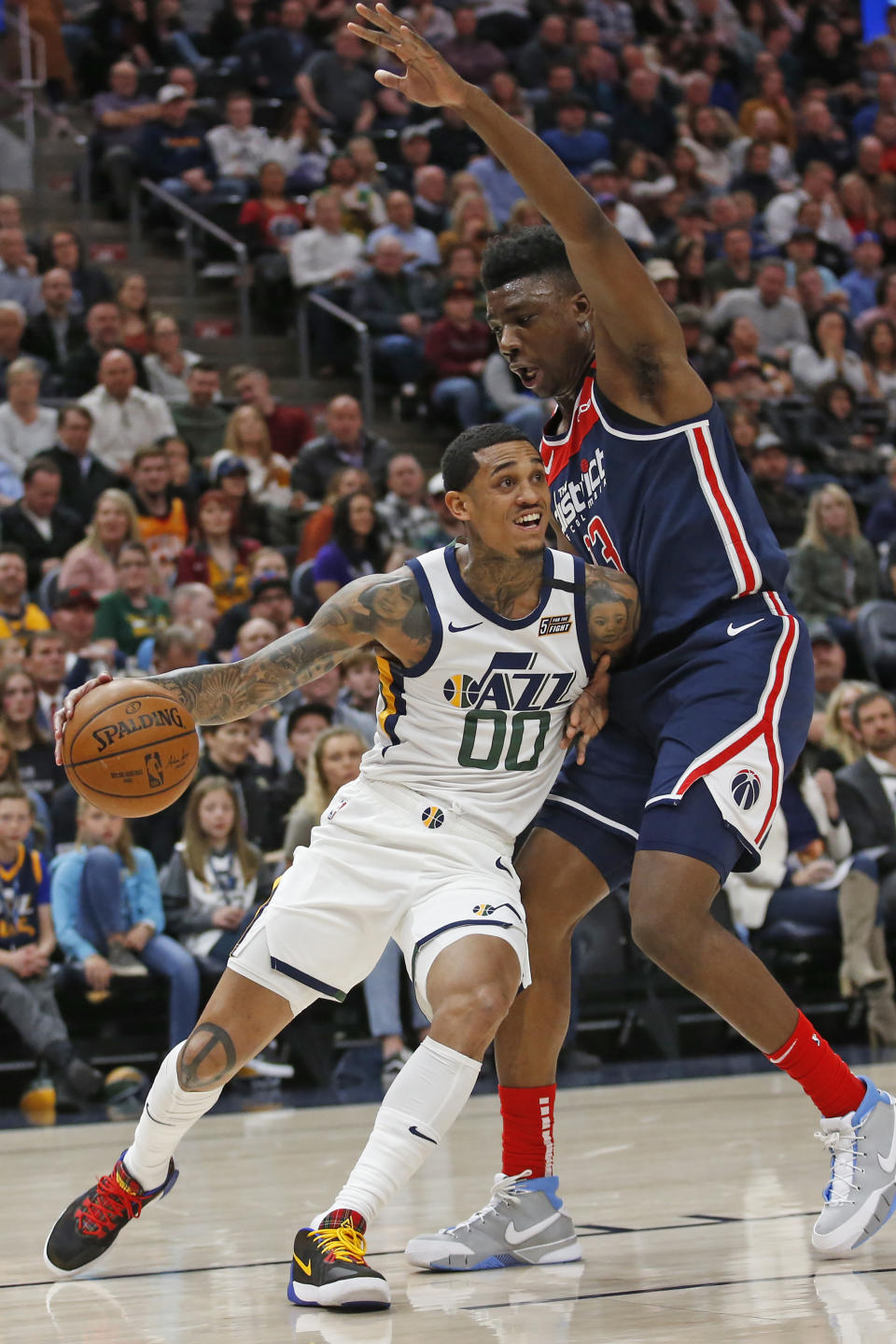 Washington Wizards center Thomas Bryant, right, guards Utah Jazz guard Jordan Clarkson (00) in the first half during an NBA basketball game Friday, Feb. 28, 2020, in Salt Lake City. (AP Photo/Rick Bowmer)