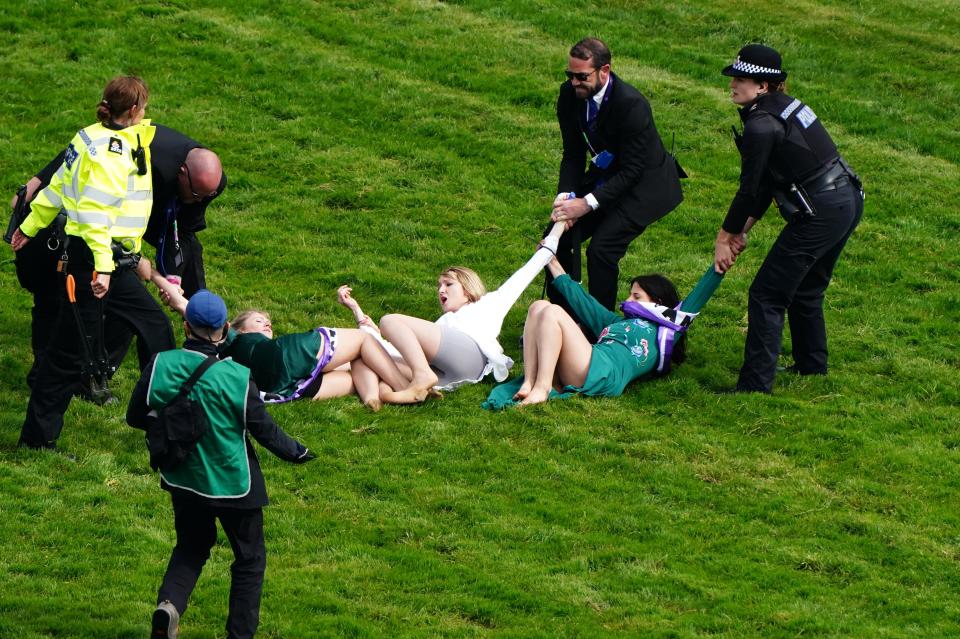 Protesters are removed from the track on Derby Day (PA)