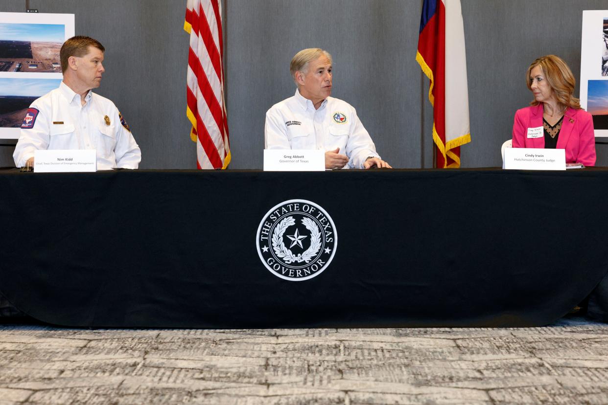 Texas Gov. Greg Abbott, center, speaks alongside Chief Nim Kidd, Texas Division of Emergency Management, left, and Hutchinson County Judge Cindy Irwin during a briefing with local and state officials about the Smokehouse Creek Fire, Friday, March 1, 2024, in Borger, Texas. Wildfires have destroyed as many as 500 structures in the Texas Panhandle, Republican Gov. Greg Abbott said Friday, March 1, 2024 describing how the largest blaze in state history scorched everything in its path, leaving ashes in its wake. ORG XMIT: TXDAM105