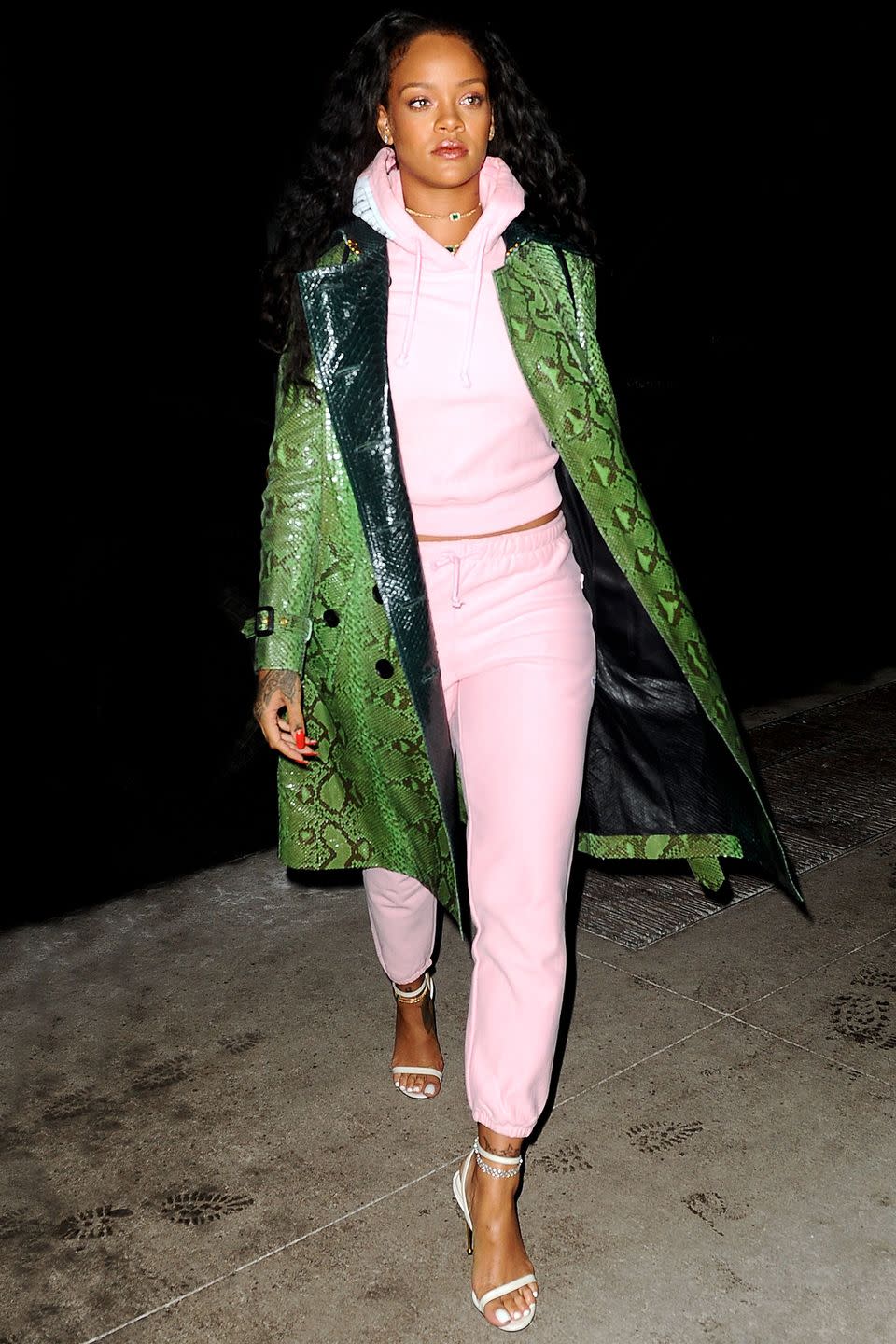 <p>In a green python-print trench, baby pink sweats and white heeled sandals while out in New York City.</p>