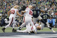 Seattle Seahawks defensive end Carlos Dunlap (8) sacks San Francisco 49ers quarterback Jimmy Garoppolo (10) in the end zone for a safety to tie the game during the second half of an NFL football game, Sunday, Dec. 5, 2021, in Seattle. (AP Photo/John Froschauer)