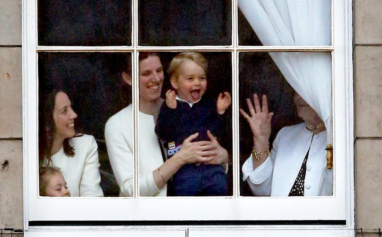 Prince George wears a Trotters boat cardigan watching Trooping the Colour from inside Buckingham Palace in June 2015