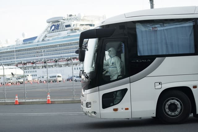 A bus carrying passengers from the quarantined Diamond Princess cruise ship leaves a port in Yokohama, near Tokyo