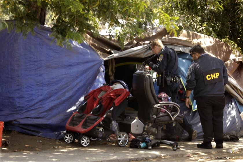 VAN NUYS, CA - JUNE 14, 2022 - - CHP officers investigate the site where a man, accused of shooting and seriously injuring a California Highway Patrol officer during a traffic stop in Studio City, was arrested at a homeless encampment along Gloria Avenue in Van Nuys on June 14, 2022. Pejhmaun Iraj Khosroabadi, 33, was considered armed and dangerous before he was found hiding inside a tent on Gloria Avenue in Van Nuys. (Genaro Molina / Los Angeles Times)