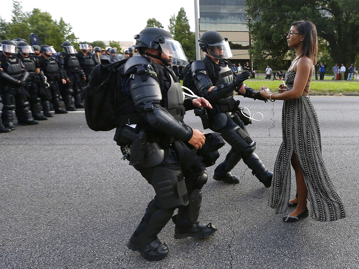 Iesha Evans, the young woman who at the Baton Rouge protests last summer stood serenely as two heavily armed policemen in riot gear rushed at her, proves that that spirit of defiance is still alive today: Reuters