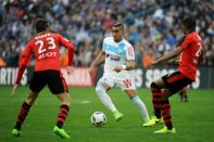 Olympique de Marseille's Dimitri Payet (C) controls the ball during their match against Rennes on February 18, 2017, at the Velodrome stadium in Marseille, southern France