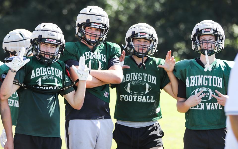 Abington football players take a break during preseason practice at Frolio Field on Wednesday, Aug. 23, 2023.