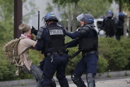 French police apprehend a youth during a demonstration to protest the government's proposed labour law reforms in Nantes, France, May 26, 2016. REUTERS/Stephane Mahe