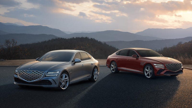 Front 3/4 view of two Genesis G80 sedans, one grey and one red