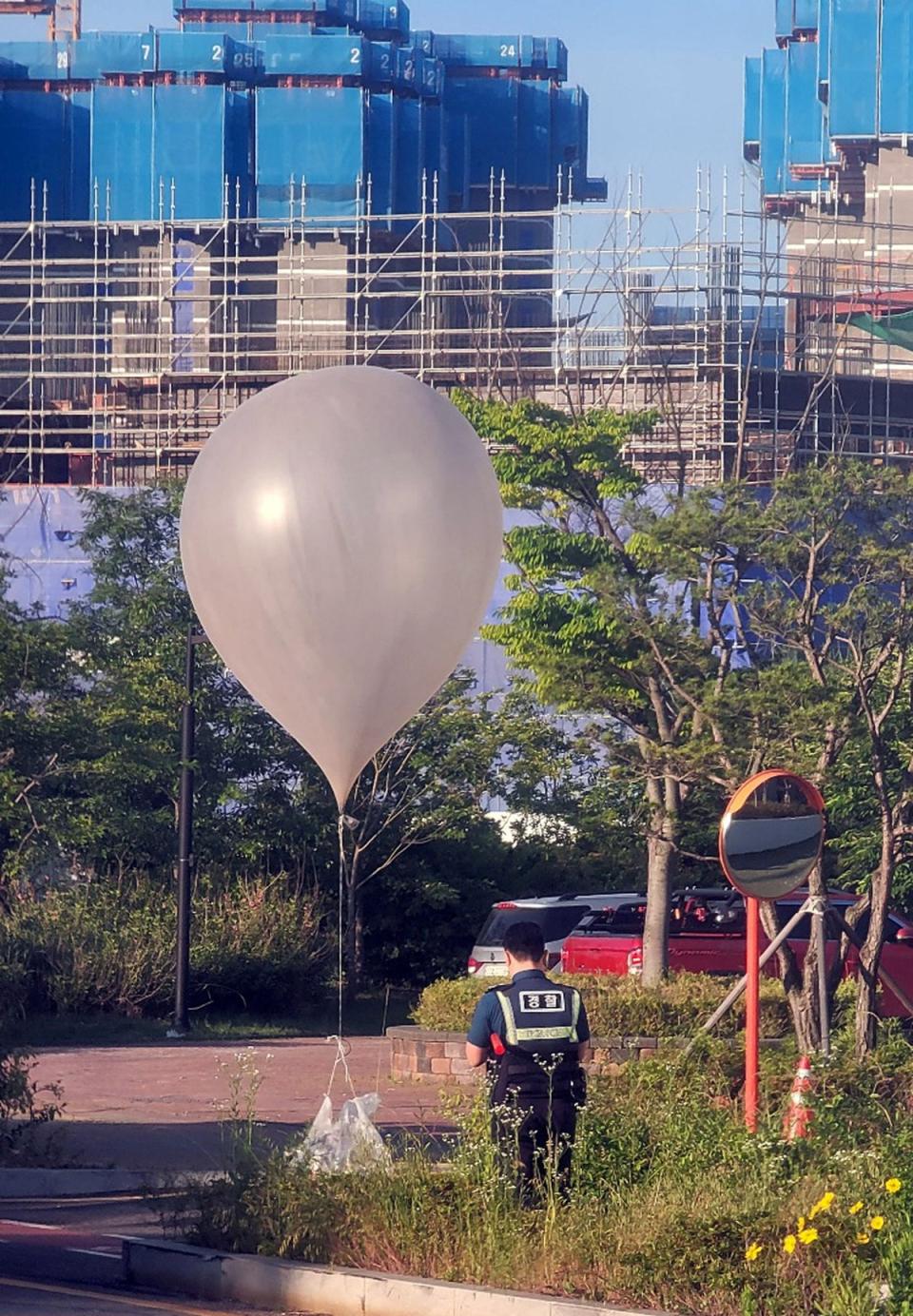 A balloon believed to have been sent by North Korea, carrying various objects including what appeared to be trash (Reuters)